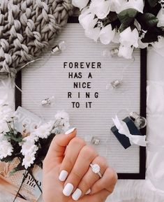 a woman's hand holding a ring with the words forever has a nice ring to it