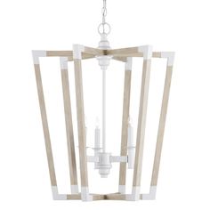 a wooden light fixture hanging from the ceiling with two white candles in front of it