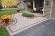 a brick walkway in front of a house