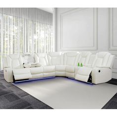 a large white couch sitting on top of a carpeted floor next to a window