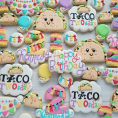 decorated cookies with happy birthday and taco themed words are displayed on a white surface