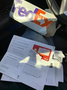 there is a bag and some papers in the car