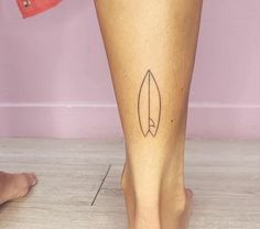 a woman's foot with a tattoo on her left leg and an arrow in the middle