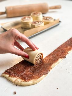 a person rolling dough on top of a table