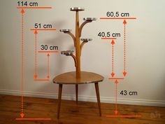 a three tiered wooden table with measurements on it