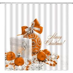 a christmas shower curtain with orange ornaments and bows on it's side, in front of a white background that says merry christmas