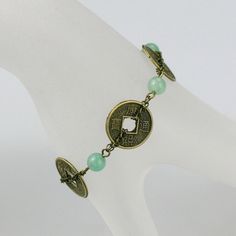 "The link bracelet is handmade using semi precious stone jade and vintage coin. Free US shipping For matching earrings, please go to: https://www.etsy.com/listing/122109597/jade-and-antique-coin-hoop-earrings For matching necklace, please go to: https://www.etsy.com/listing/197905450/antique-coin-charm-jade-collar-necklace?ref=shop_home_active_1 Customers who purchased this item said: \"I bought a number of items from this shop including earrings and a necklace. Each one is exquisitely made, uni Adjustable Vintage Jade Bracelets, Vintage Jade Jewelry For Jewelry Making, Antique Nickel-free Bracelet As Gift, Vintage Jade Bracelets, Vintage Jade Round Bracelets, Vintage Round Jade Bracelets, Antique Jade Jewelry As A Gift, Antique Round Beads Jewelry As Gift, Antique Jade Jewelry For Gift