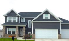 a large house with two garages in the front and one on the other side