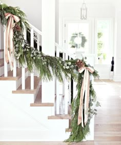 christmas garland on the stairs with pine cones and greenery