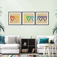 three colorful hearts are on the wall in this living room