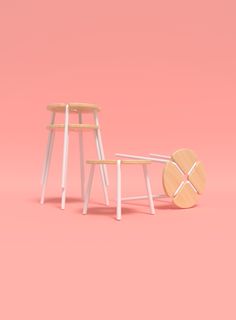 two stools and a table against a pink background with the same chair on one side