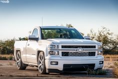 a white truck is parked in the dirt