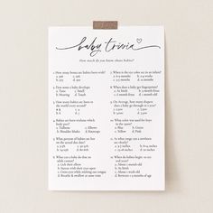 a baby shower checklist hanging on a wall with the words baby twins written in cursive font