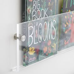 three books are sitting on the shelf next to each other in front of a white door