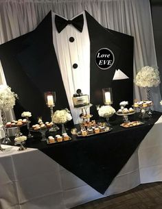 a black and white tuxedo themed dessert table