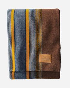 a blanket with yellow and blue stripes on it