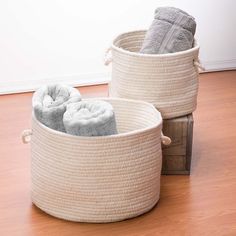 two baskets on the floor with towels in them