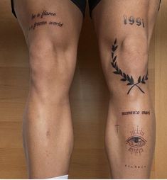 two men with tattoos on their legs, one has an eye and the other has a cross