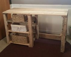 a wooden desk with baskets under it in a room next to a wall and door