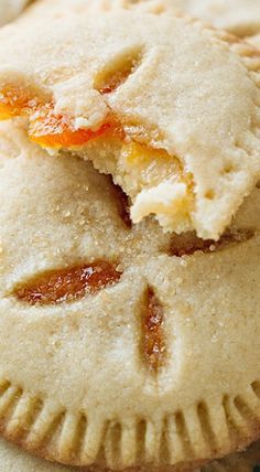 a close up of a pie with an orange slice in the middle and some other pastries around it