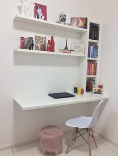 there is a desk and chair in the room with bookshelves on the wall