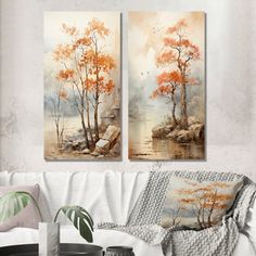 two paintings hanging on the wall above a couch