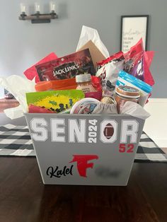 a basket filled with food sitting on top of a wooden table next to a wall