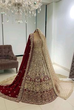 a bridal gown on display in front of a chandelier