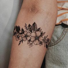 a black and white flower tattoo on the arm