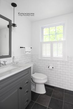 a white toilet sitting next to a sink in a bathroom under a window with shutters