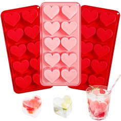 three heart shaped ice trays with two glasses and one drink in the foreground