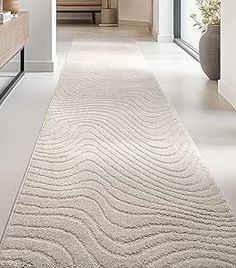 a long white rug with wavy lines on the floor