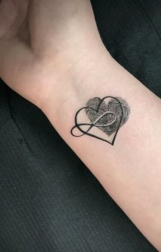 a black and white photo of a heart shaped finger tattoo