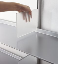 a person reaching for something in a drawer