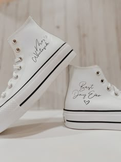 a pair of white shoes with writing on them