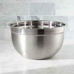 a stainless steel bowl on a marble countertop