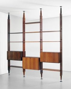 two bookshelves with wooden shelves in an empty room