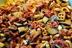 a pile of chex mix with bacon and peanuts