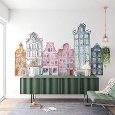 a living room with a large wall mural on the wall and a green chair in front of it