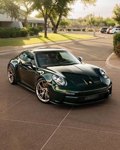 a green sports car parked on the street