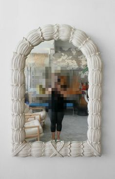 a person standing in front of a mirror that has been made to look like an image