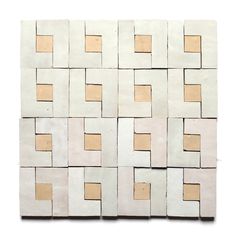 a white and brown tile with squares on the top, in different sizes and colors