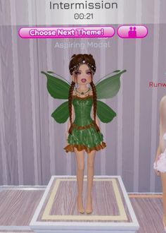 the doll is wearing a green dress with brown trims on it's wings