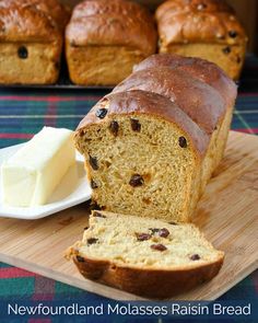 a loaf of bread sitting on top of a wooden cutting board next to some butter