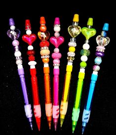 several different colored pens with hearts on them