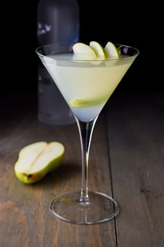 an apple martini garnished with sliced apples