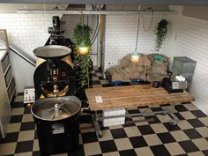 a room with black and white checkered flooring, an old fashioned coffee maker