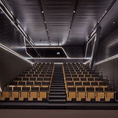 an empty auditorium with rows of yellow seats