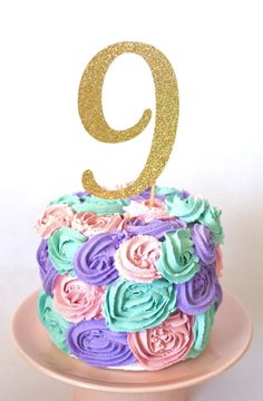 there is a cake that has the number nine on it and flowers all over it