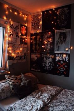 a bedroom with lights and posters on the wall above the bed, along with other decorations